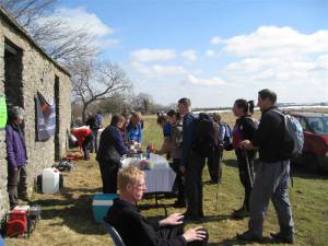 Walkers receiving sausages in bread roll and drinks at halfway on long route